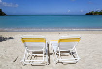 Two sunbeds on the sand with gentle waves breaking on Morne Rouge Beach known locally as BBC Beach with the turqoise sea beyondBeaches Resort Sand Sandy Scenic Seaside Shore Tourism West Indies 2 Car...