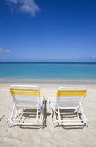 Two sunbeds on the sand with gentle waves breaking on Morne Rouge Beach known locally as BBC Beach with the turqoise sea beyondBeaches Resort Sand Sandy Scenic Seaside Shore Tourism West Indies 2 Car...