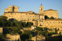 Gordes.  Hilltop village houses  church and sixteenth century chateau in warm glow of evening light.16th c. castle European French Western Europe Castillo Castello Scenic Warm Light Castle Castello C...