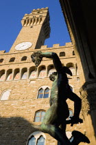 Piazza della Signoria 1554 bronze statue of Perseus holding the head of Medussa by Cellini beside the campanile belltower of the Palazzo VecchioEuropean Italia Italian Southern Europe Toscana Tuscan...