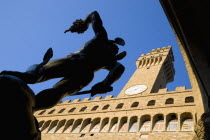 Piazza della Signoria 1554 bronze statue of Perseus holding the head of Medussa by Cellini beside the campanile belltower of the Palazzo VecchioEuropean Italia Italian Southern Europe Toscana Tuscan...