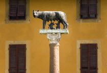 The Campo dei Miracoli or Field of Miracles. A bronze statue of Romulus and Remus feeding from a standing she wolf in front of a yellow ochre buildingEuropean Italia Italian Southern Europe Toscana T...