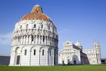 Campo dei Miracoli or Field of Miracles The Baptistry Duomo Cathedral and Leaning Tower belltower or Torre Pendente under a blue sky with tourist walking at their baseEuropean Italia Italian Southern...