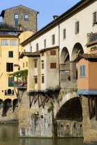 The 14th Century Ponte Vecchio or Old Bridge across the River Arno showing the backs of the goldsmiths workshops that hang over the waterEuropean Italia Italian Southern Europe Toscana Tuscan Firenze...