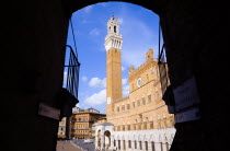 The Torre del Mangia campanile belltower of the Palazzo Publico seen through the archway of the narrow sidestreet Chiasso del BargelloEuropean Italia Italian Southern Europe Toscana Tuscan History Ho...