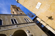 Val D Orcia Piazza Pio II with Palazzo Communale Town Hall with its campanile belltower with an ancient lantern holder set into the corner of a wallEuropean Italia Italian Southern Europe Toscana Tus...