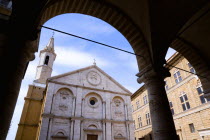 Val D Orcia The Duomo in Piazza Pio II seen through an arch. Built in 1459 by the architect Rossellino for Pope Pius IIEuropean Italia Italian Southern Europe Toscana Tuscan History Religion Religiou...