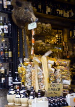 Shop display of chianti wines  pastas and wild boar products with a stuffed wild boar head on the wallEuropean Italia Italian Southern Europe Toscana Tuscan Store