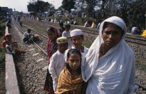 Muslim men and women gathered along the railway track at Biswas Ijtema with woman and children in the foregroundMoslem Asia Asian Bangladeshi Dacca Female Woman Girl Lady Female Women Girl Lady Islam...