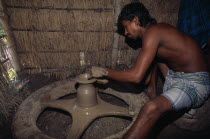Potter shaping clay pot on wheel.Asia Asian Bangladeshi One individual Solo Lone Solitary Asia Asian Bangladeshi One individual Solo Lone Solitary