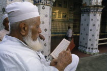 Man reading the Koran.Chand Masjid Dacca Moslem Asia Asian Bangladeshi Islam Male Men Guy Muslim Old Senior Aged Quran Religion Religion Religious Muslims Islam Islamic Chand Masjid Dacca Moslem Asi...