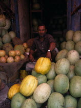 Man selling durians and melons in fruit market.Asia Asian Bangladeshi Dacca Male Men Guy Old Senior Aged One individual Solo Lone Solitary 1 Male Man Guy Single unitary Asia Asian Bangladeshi Dacca...
