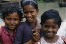 Head and shoulders group portrait of three smiling young girls.3 Asia Asian Bangladeshi Happy Immature Kids Contented Young Unripe Unripened Green 3 Asia Asian Bangladeshi Happy Immature Kids Conten...