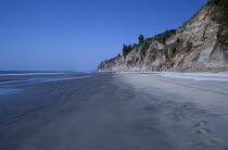 Empty beach and eroded cliff.Asia Asian Bangladeshi Beaches Resort Sand Sandy Seaside Shore Tourism Cliffs Drop Steep Overlooking Sand Sandy Beach Tourism Seaside Shore Tourist Tourists Vacation Sand...