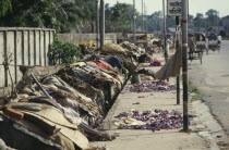 Roadside slum dwellings along pavement in city centre.shanty town poor poverty homes houses Asia Asian Bangladeshi Center Dacca Ecology Entorno Environmental Environnement Green Issues  shanty town...