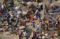 Elevated view over customers and vendors at fruit and vegetable street market in Agargoan slum.Asia Asian Bangladeshi Dacca Shanty Asia Asian Bangladeshi Dacca Shanty
