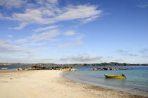 Sandy beach & clear waters with yellow boat anchored near shorelineAlba Beaches Great Britain Northern Europe Resort Seaside Tourism UK United Kingdom British Isles European Sand Sandy Beach Tourism...