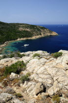 Rocky coastline & deep blue waters with boat  coastline near Calviportrait Northern French Western Europe European portrait Northern French Western Europe European