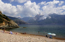 Plage De Bussaglia  shingle beach with umbrellas & bathers & Capo dOrta mountainsBeaches Oporto Resort Sand Sandy Seaside Shore Tourism French Western Europe European Sand Sandy Beach Tourism Seaside...