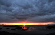 Sunset over small islands and north tip of IonaAlba Great Britain Northern Northern Europe UK United Kingdom British Isles European Sundown Atmospheric Alba Great Britain Northern Northern Europe UK...