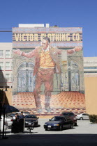 Mural depicting clothing history downtown  fashion district. Valet parking lot below.Downtown American Destination Destinations North America Northern United States of America LA The Golden State
