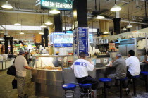 Central Market scene with people sat around a seafood bar.Downtown American Destination Destinations North America Northern United States of America Inn LA Pub Tavern The Golden State