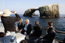 Tour boat passing Arch Rock  East Anacapa  Channel IslesSanta Barbara American Destination Destinations North America Northern United States of America Gray Holidaymakers The Golden State Tourism Tou...