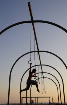 Gymnast silhoutted on the rings  Santa Monica beachSanta Monica American Beaches Destination Destinations North America Northern Resort Sand Sandy Seaside Shore Tourism United States of America LA On...