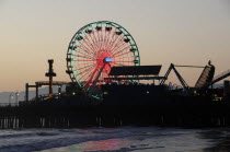 Santa Monica pier Silhouetted at dusk. Ferris wheel funfairSanta Monica American Destination Destinations Nite North America Northern United States of America Night Nightfall Twilight Evenfall Crespu...