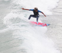 Riding the surf at Huntington BeachSouth Beaches American Destination Destinations North America Northern Resort Sand Sandy Seaside Shore Southern Tourism United States of America Gray LA One individ...