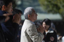 Jingumae - in front of Meijijingu shrine  gray haired man about sixty years old praying  New Years worshipAsia Asian Japanese Nihon Nippon Grey Male Men Guy Old Senior Aged Religion Religious