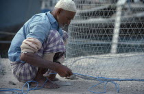 Fisherman preparing netsal-Kuwayt Male Man Guy Middle East Kuwaiti Male Men Guy One individual Solo Lone Solitary 1 al Kuwayt Single unitary