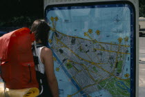 Backpacker looking at tourist map.European French Holidaymakers One individual Solo Lone Solitary Sightseeing Tourism Tourists Western Europe European French Holidaymakers One individual Solo Lone S...
