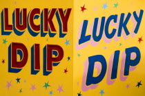Findon village Sheep Fair Colourful yellow sign for a Lucky Dip fairground stall.Great Britain Northern Europe UK United Kingdom British Isles European