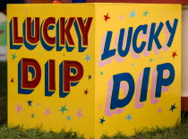 Findon village Sheep Fair Colourful yellow sign for a Lucky Dip fairground stall.Great Britain Northern Europe UK United Kingdom British Isles European