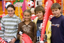 Findon village Sheep Fair Two teenage boys and two girls holding prizes won at fairground stalls.Great Britain Northern Europe UK United Kingdom British Isles European