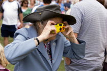 Findon village Sheep Fair Elderly lady taking a photograph with a disposable analogue film camera.Great Britain Northern Europe UK United Kingdom British Isles European