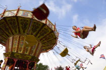 Findon village Sheep Fair Children in motion riding on a swing carousel.Great Britain Northern Europe UK United Kingdom British Isles European