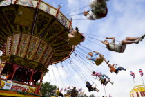 Findon village Sheep Fair Children in motion riding on a swing carousel.Great Britain Northern Europe UK United Kingdom British Isles European