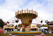 Findon village Sheep Fair Children in motion riding on a swing carousel.Great Britain Northern Europe UK United Kingdom British Isles European