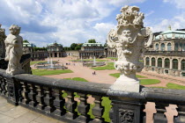 The central Courtyard of the restored Baroque Zwinger Palace gardens busy with tourists seen from the Rampart lined with statues originally built between 1710 and 1732 after a design by Matthus Daniel...