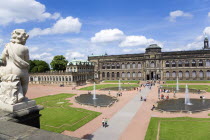 The central Courtyard and Picture Gallery of the restored Baroque Zwinger Palace gardens busy with tourists seen from the statue lined Rampart originally built between 1710 and 1732 after a design by...