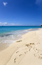 South Glossy Beach in Glossy Bay with waves breaking on the shoreline of the turqoise sea.Beaches Resort Sand Sandy Scenic Seaside Shore Tourism West Indies Caribbean Destination Destinations Salt Wa...