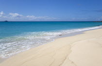 South Glossy Beach in Glossy Bay with waves breaking on the shoreline of the turqoise sea.Beaches Resort Sand Sandy Scenic Seaside Shore Tourism West Indies Caribbean Destination Destinations Salt Wa...