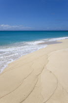 South Glossy Beach in Glossy Bay with waves breaking on the shoreline of the turqoise sea.Beaches Resort Sand Sandy Scenic Seaside Shore Tourism West Indies Caribbean Destination Destinations Salt Wa...