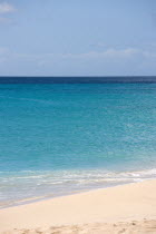 South Glossy Beach in Glossy Bay with waves breaking on the shoreline of the turqoise sea.Beaches Resort Sand Sandy Scenic Seaside Shore Tourism West Indies Caribbean Destination Destinations Salt Wa...