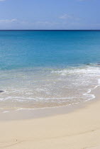 South Glossy Beach in Glossy Bay with waves breaking on the shoreline of the turqoise sea.Beaches Resort Sand Sandy Scenic Seaside Shore Tourism West Indies Caribbean Destination Destinations Salt Wa...