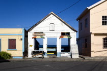 Derelict building in the main street of Hillsborough with the harbour and sea visible through the empty building.Beaches Resort Sand Sandy Scenic Seaside Shore Tourism West Indies Caribbean Destinati...