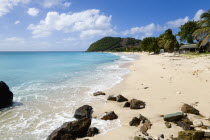 South Glossy Beach in Glossy bay with footprints in the sand and waves from the turqoise sea breaking on the shore.Beaches Caribbean Destination Destinations Resort Sand Sandy Scenic Seaside Shore To...