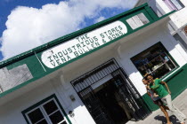 Hillsborough Hardware shop The Industrious Stores owned by Vena Bullen and Sons with two smiling girls walking past in the main street.Beaches Caribbean Destination Destinations Grenadian Greneda Res...